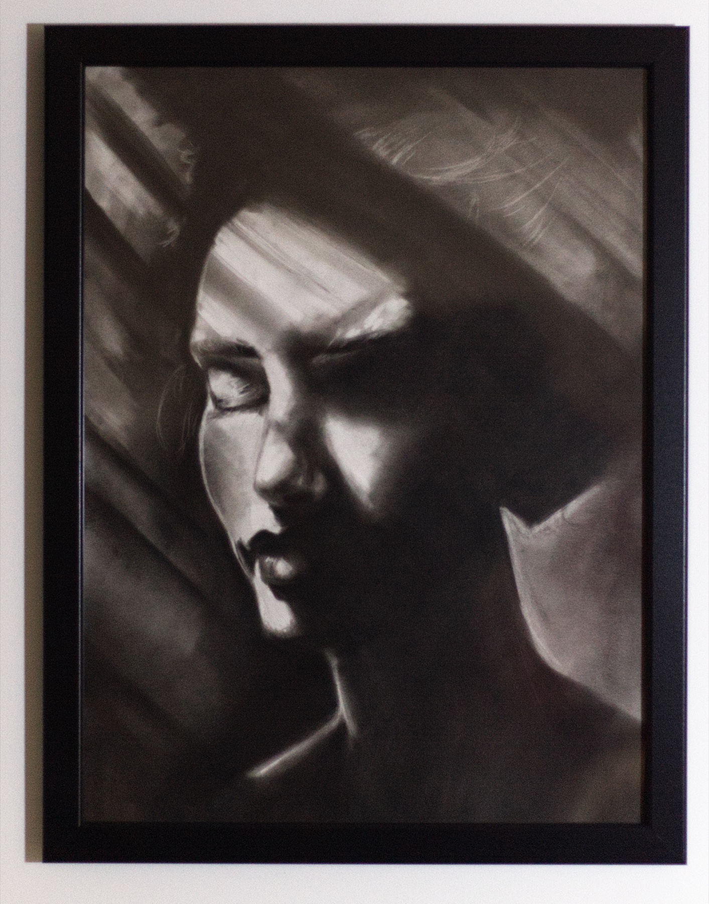 Oblique Silence, a portrait with closed eyes divided by a diagonal of light