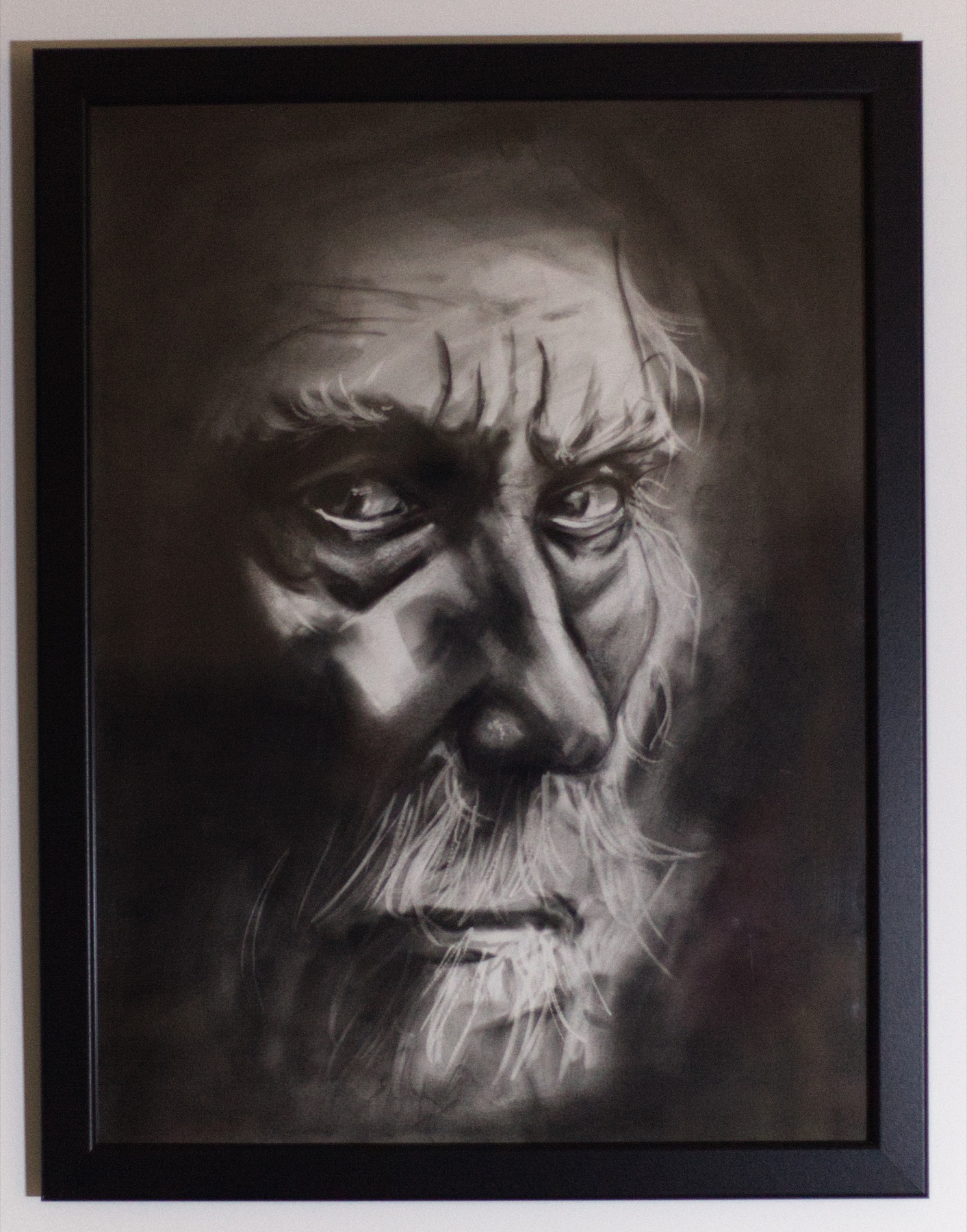 The Elder, a direct black-and-white portrait of an older face marked by time