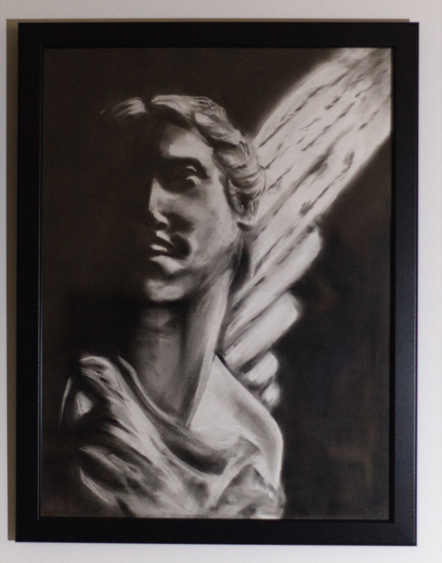 Winged Figure, a pale classical winged figure appearing against darkness